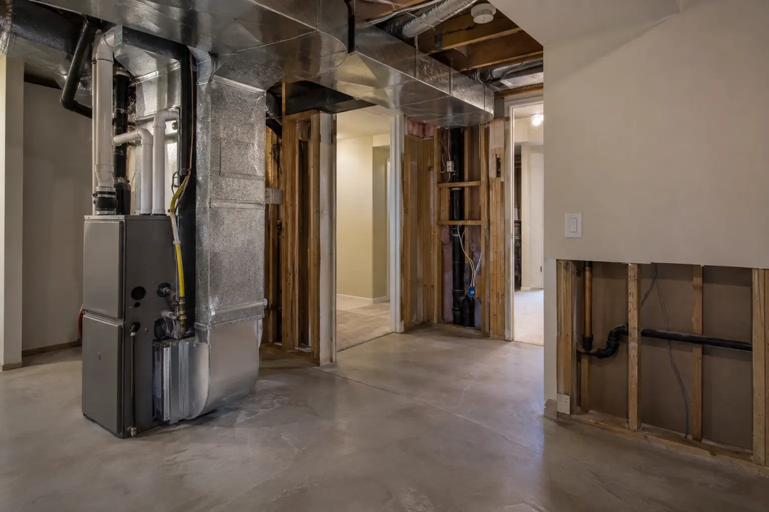Mechanical area with selected wall openings during a basement assessment.