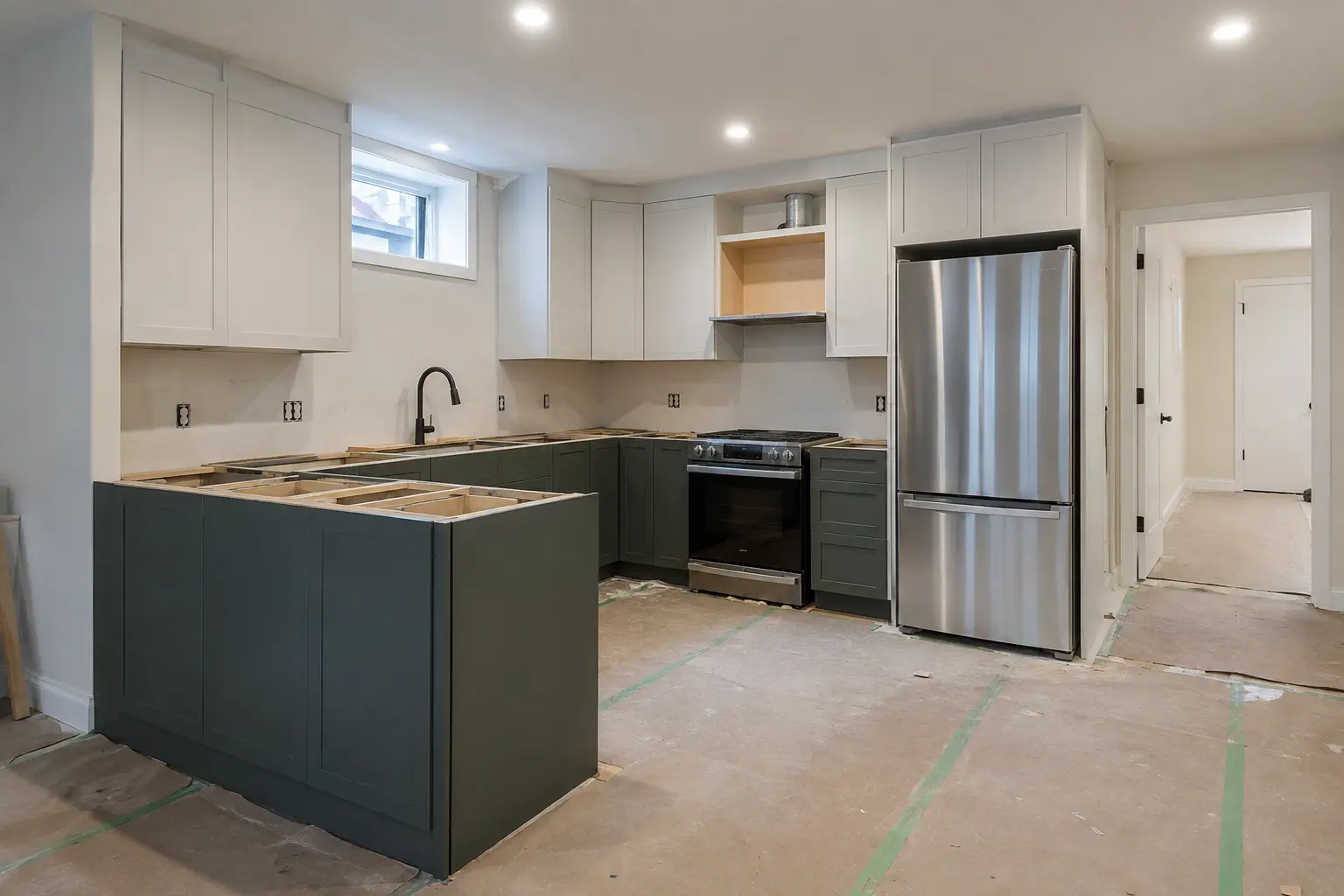Basement suite kitchen during cabinet installation.
