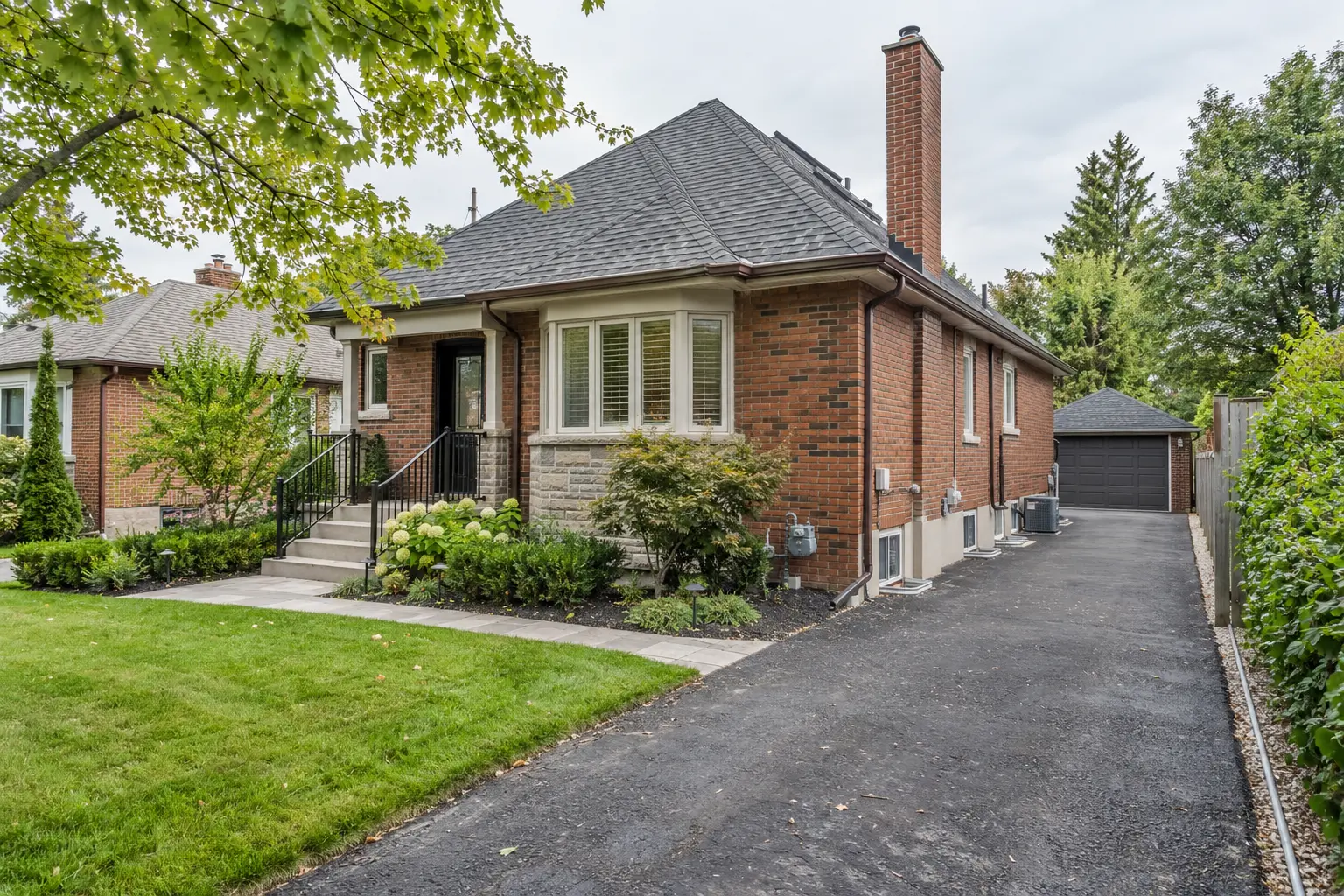 Oakville detached house with a separate side path leading toward a basement entrance.